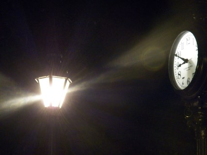 clock at night near a lamp