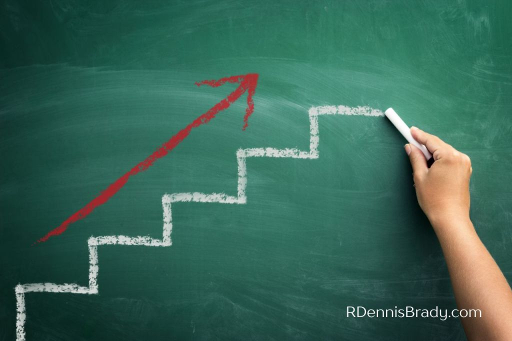 chalkboard with steps and arrow tracking progress