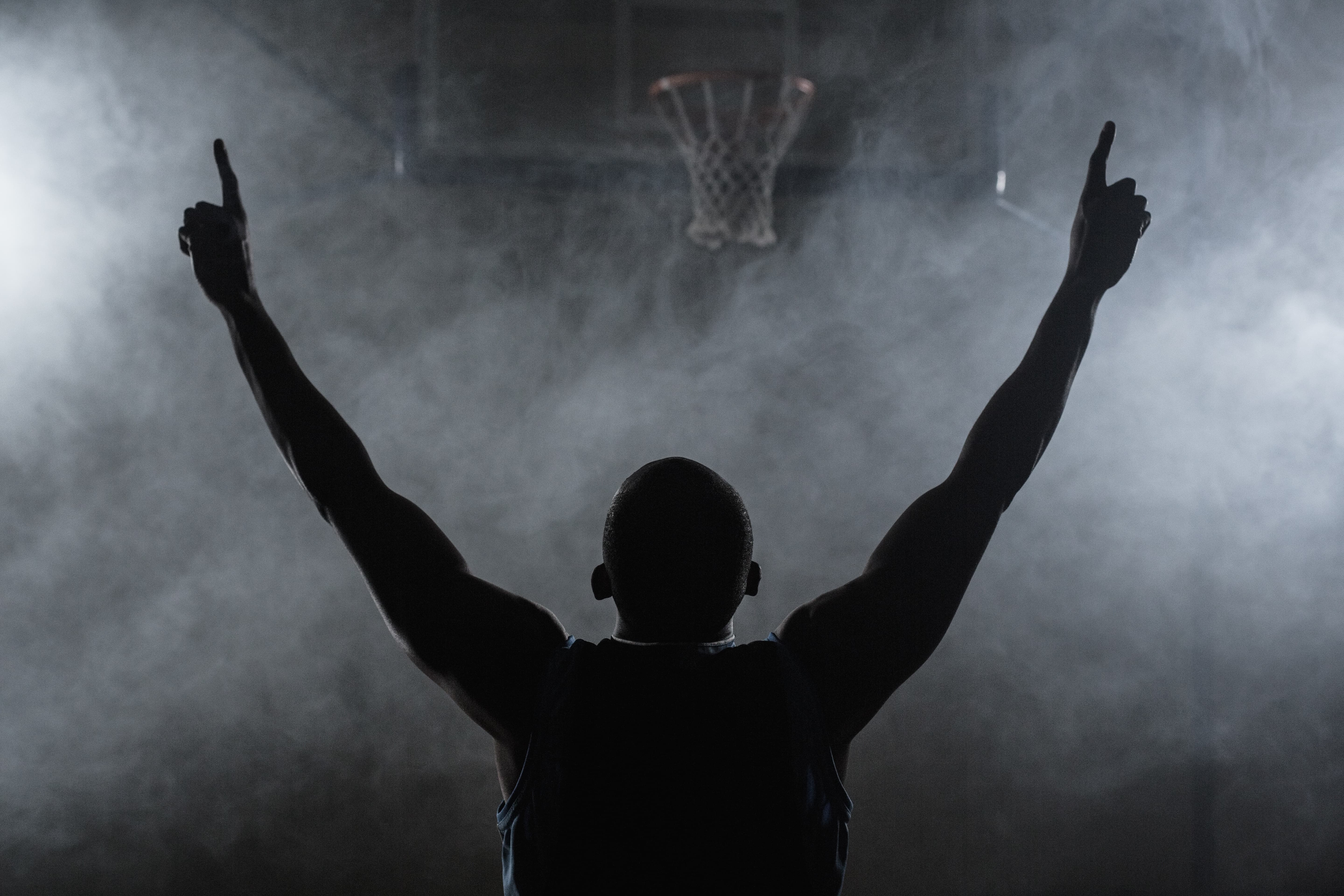 man has hands raised in victory