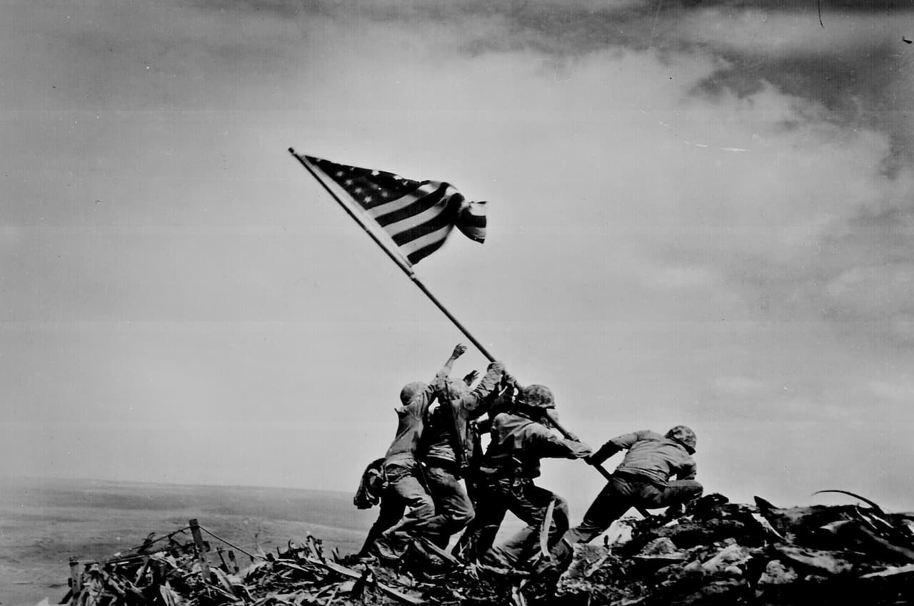 American soldiers raising flag at Iwo Jima in WWII