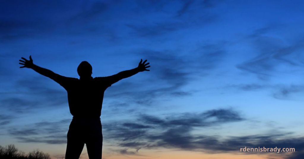 man lifting his hands in worship