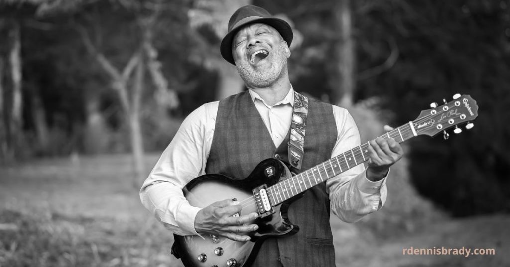 man singing and playing guitar
