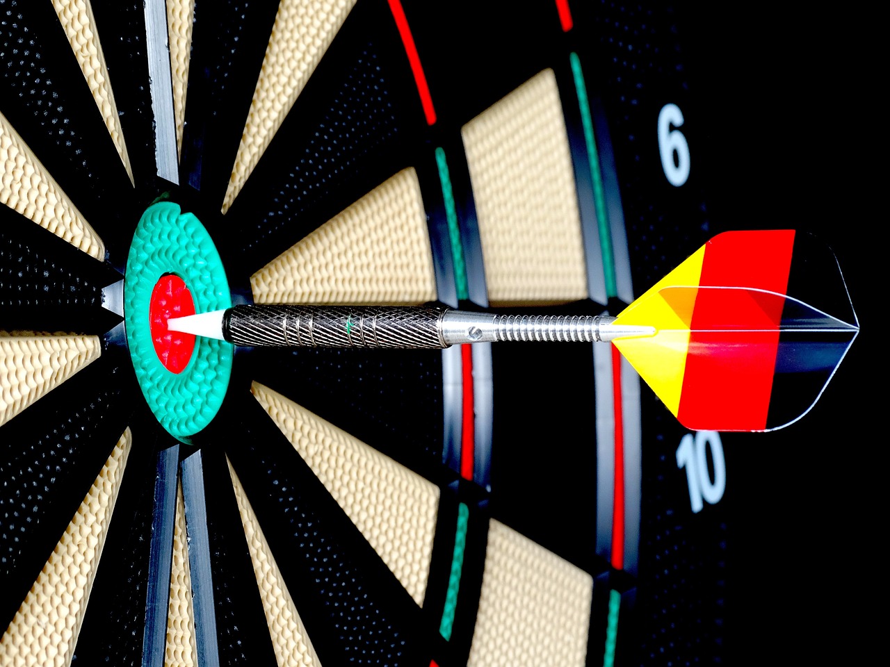 a dart on the bullseye of a dart board
